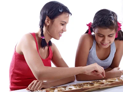 Older Sister Teaching Mancala